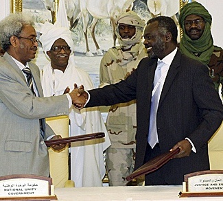 Sudanese rebel Justice and Equality Movement (JEM) representative Jibril Ibrahim shakes hands with Amin Hassan Omar
