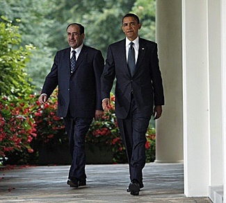 U.S. President Obama and Iraq's Prime Minister al-Maliki walk to the Rose Garden to hold a news conference at the White House in Washington