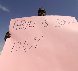A man from the Dinka tribe holds a placard during a demonstration in Khartoum