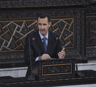 Syrian President Bashar Al-Assad addresses the parliament in Damascus