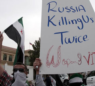 Syrians living in Qatar, take part in a protest in front of the Russian embassy in Doha
