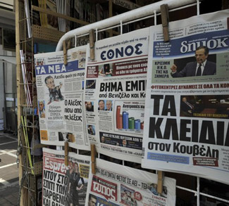 Newspapers are displayed at a kiosk in A