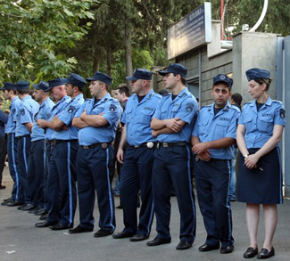 Georgian police officers block the entra
