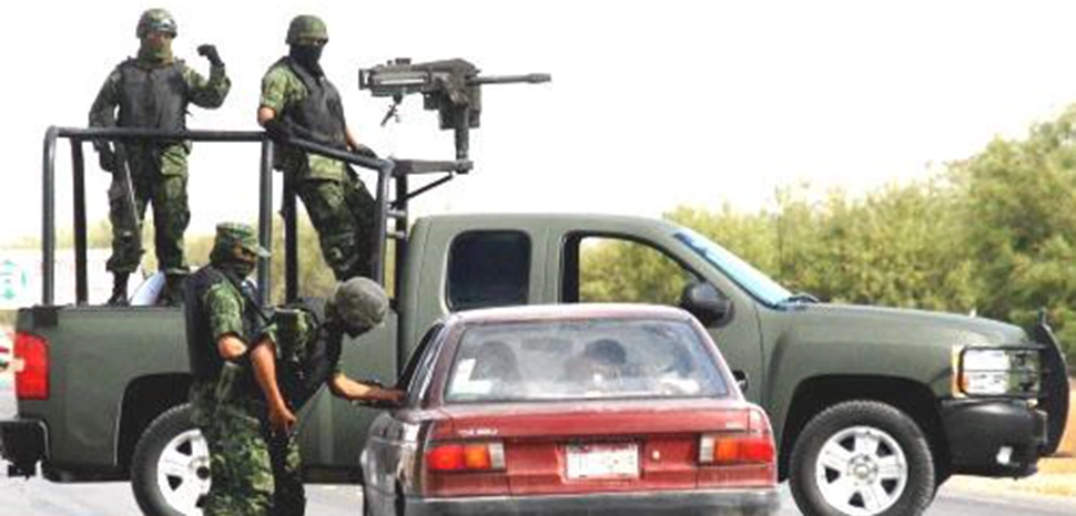 cc en:User:Homan05, modified, Mexican troops armed with a Mark 19 40mm automatic grenade launcher operating a random checkpoint in March 2009. / https://en.m.wikipedia.org/wiki/File:Mexican_troops_operating_at_a_random_checkpoint_2009.jpg