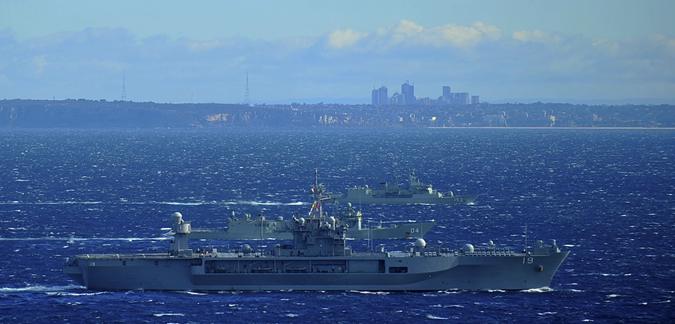                 cc Naval Surface Warriors, modified, 150713-N-ZZ999-450 CORAL SEA (July 13, 2015) - The U.S. 7th Fleet flagship USS Blue Ridge (LCC 19) steams along the the Australian coast with Royal Australian Navy frigates HMAS Darwin (FFH 04) and HMAS Stuart (FFH 153) as she departs Sydney. Blue Ridge is currently providing support for 7th Fleet's involvement in the biennial U.S.-Australia exercise Talisman Sabre 2015, while patrolling the 7th Fleet area of operations. (U.S. Navy photo by Mass Communication Specialist 3rd Class Don Patton/ RELEASED) / https://www.flickr.com/photos/navalsurfaceforces/19724470871/
              