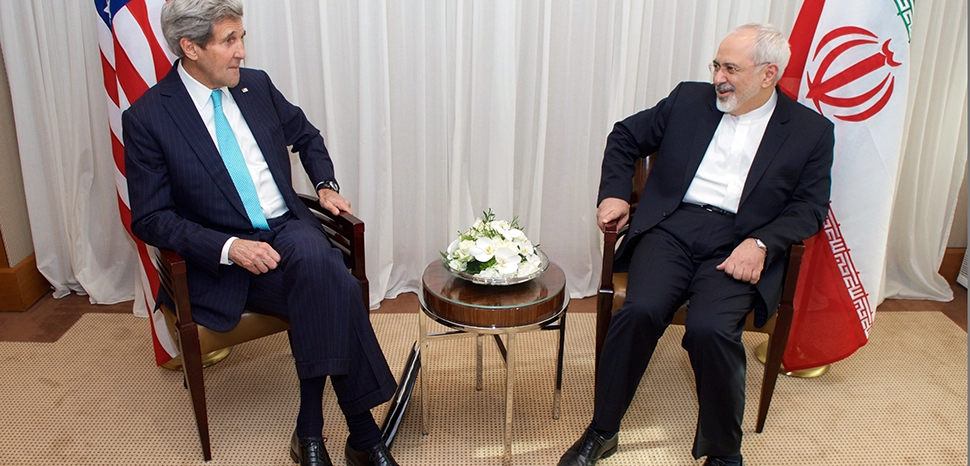 Kerry Zarif Iran nuclear deal, cc US Department of State, modified, https://en.m.wikipedia.org/wiki/File:Secretary_Kerry_Discusses_Iranian_Nuclear_Program_With_Foreign_Minister_Zarif_in_Switzerland_%2816092274037%29.jpg / U.S. Secretary of State John Kerry sits with Iranian Foreign Minister Javad Zarif before the two resume negotiations about the future of Iran's nuclear program on January 14, 2015, in Geneva, Switzerland. [State Department photo/ Public Domain]