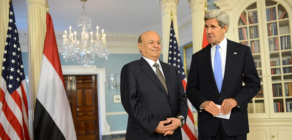 cc US Department of State, modified, https://en.m.wikipedia.org/wiki/File:Secretary_Kerry_and_Yemeni_President_Hadi_Address_Reporters.jpg