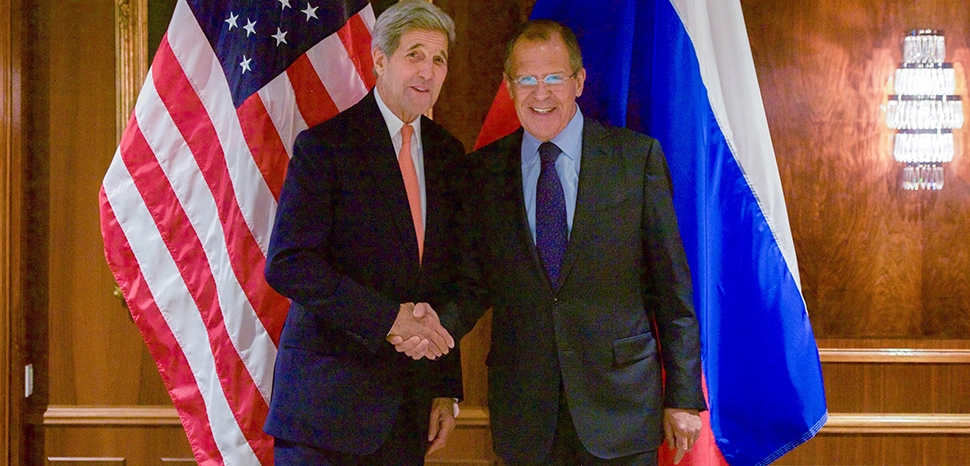                 cc US State Department, modified, https://commons.wikimedia.org/wiki/File:Secretary_Kerry_Shakes_Hands_With_Russian_Foreign_Minister_Lavrov_Before_Bilateral_Meeting_in_Austria_Focused_on_Syria_%2821785218013%29.jpg / U.S. Secretary of State John Kerry shakes hands with Foreign Minister Sergey Lavrov on October 23, 2015, at the Imperial Hotel in Vienna, Austria, before a bilateral meeting focused on Syria. [State Department photo/ Public Domain]
              