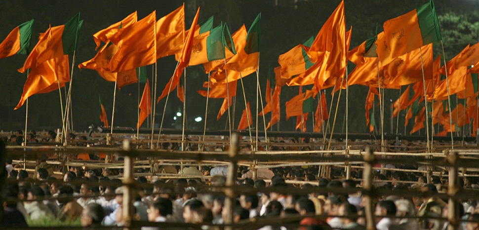 cc Al Jazeera English, modiifed, Party flags of Bharatiya Janta Party (BJP) and Shiv Sena on display as Lal Krishna Advani, the oppositions prime ministerial candidate, addresses an election rally in the western Indian city of Mumbai. / https://commons.wikimedia.org/wiki/File:BJP_and_Shiv_Sena_flags_-_Flickr_-_Al_Jazeera_English.jpg