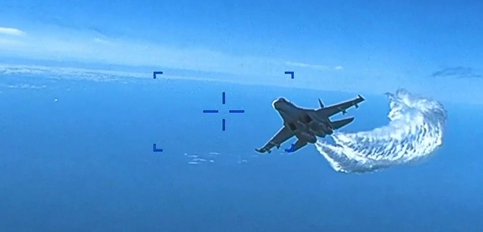 Two Russian Su-27 aircraft conducted an unsafe and unprofessional intercept with a U.S. Air Force intelligence, surveillance, and reconnaissance unmanned MQ-9 aircraft operating within international airspace over the Black Sea on March 14, 2023. Russian Su-27s dumped fuel upon and struck the propeller of the MQ-9, causing U.S. forces to have to bring the MQ-9 down in international waters. Screenshot from video. / https://simple.m.wikipedia.org/wiki/File:US_Air_Force_MQ-9_camera_footage_Russian_Su-27_Black_Sea_intercept_screenshot.jpg