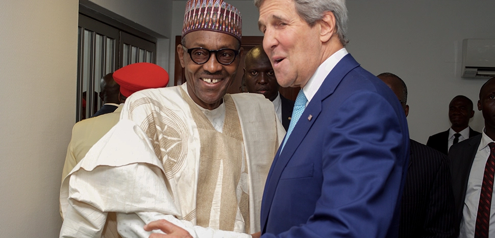                 Kerry and Buhari, Nigeria, cc US Department of State, modified, https://commons.wikimedia.org/wiki/File:Secretary_Kerry_Shakes_Hands_With_Newly_Sworn-in_Nigerian_President_Buhari.jpg
              