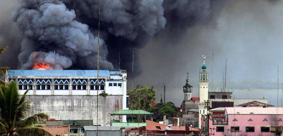 Bombing of Marawi City, cc Wikicommons Mark Jhomel, modified, https://commons.wikimedia.org/wiki/File:Bombing_on_Marawi_City.jpg