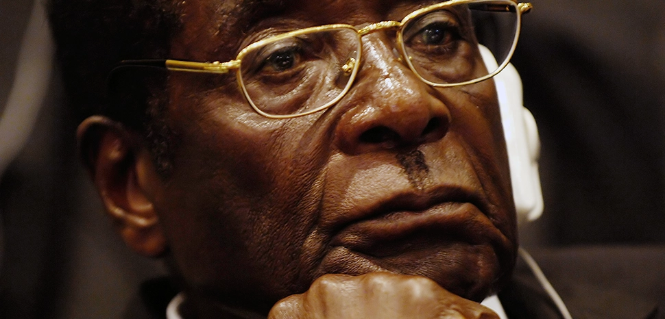                 cc Tech. Sgt. Jeremy Lock (USAF), modified, President of Zimbabwe Robert Mugabe listens as Prof. Alpha Oumar Konare, chairman of the Commission of the African Union, addresses attendees at the opening ceremony of the 10th Ordinary Session of the Assembly during the African Union Summit in Addis Ababa, Ethiopia. / https://commons.wikimedia.org/wiki/File:Mugabecloseup2008.jpg
              