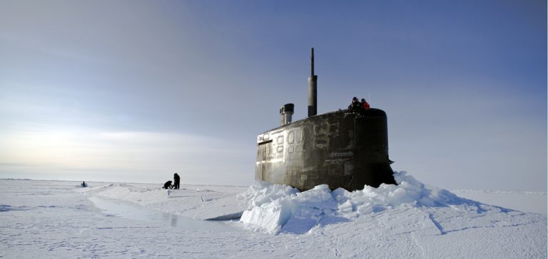 ARCTIC OCEAN (March 19, 2011) Sailors and members of the Applied Physics Laboratory Ice Station clear ice from the hatch of the Seawolf-class submarine USS Connecticut (SSN 22) as it surfaces above the ice during ICEX 2011. (U.S. Navy photo by Mass Communication Specialist 2nd Class Kevin S. O'Brien/Released)