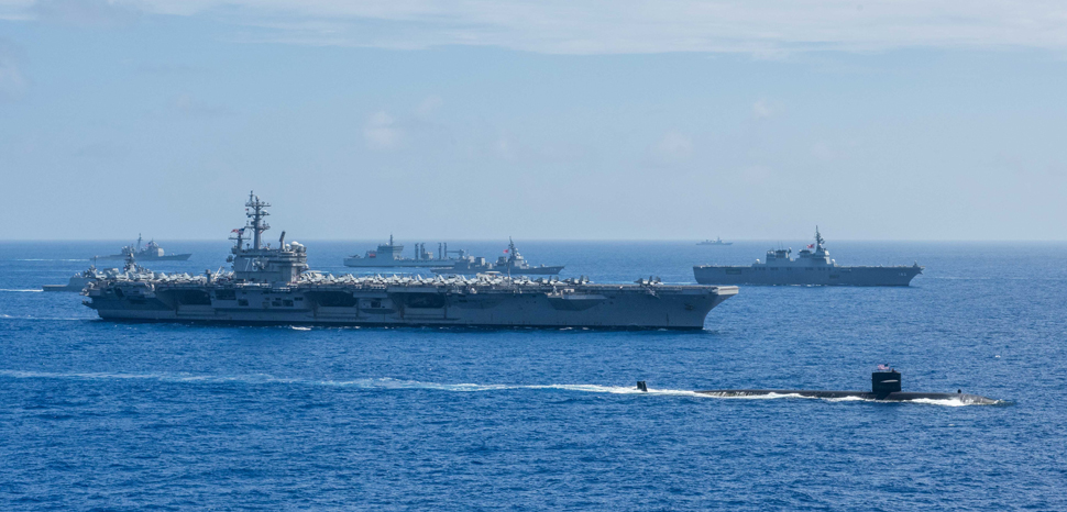 PHILIPPINE SEA (June 14, 2017) Ships from the Indian Navy, Japan Maritime Self-Defense Force (JMSDF) and the U.S. Navy sail in formation during Malabar 2018. Malabar 2018 is the 22nd rendition of the exercise and the first time it has been hosted off the coast of Guam. Malabar is designed to advance military-to-military coordination in a multinational environment between the U.S., Japan and Indian maritime forces. (U.S. Navy photo by Mass Communication Specialist 3rd Class Erwin Jacob V. Miciano/Released) 180615-N-VI515-648, modified