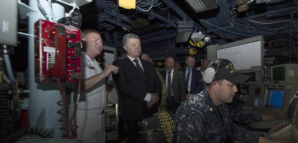                 ODESSA, Ukraine (July 17, 2017) Cmdr. Peter Halvorsen, commanding officer of the Arleigh Burke-class guided-missile destroyer USS Carney (DDG 64), shows the combat information center to President of Ukraine Petro Poroshenko while he tours the ship in Odessa, Ukraine, during exercise Sea Breeze 2017. Sea Breeze is a U.S. and Ukraine co-hosted multi-national maritime exercise held in the Black Sea and is designed to enhance interoperability of participating nations and strengthen maritime security within the region. (U.S. Navy photo by Mass Communication Specialist 3rd Class Weston Jones/Released)170717-N-ZE250-167 Join the conversation: http://www.navy.mil/viewGallery.asp http://www.facebook.com/USNavy http://www.twitter.com/USNavy http://navylive.dodlive.mil http://pinterest.com https://plus.google.com
              