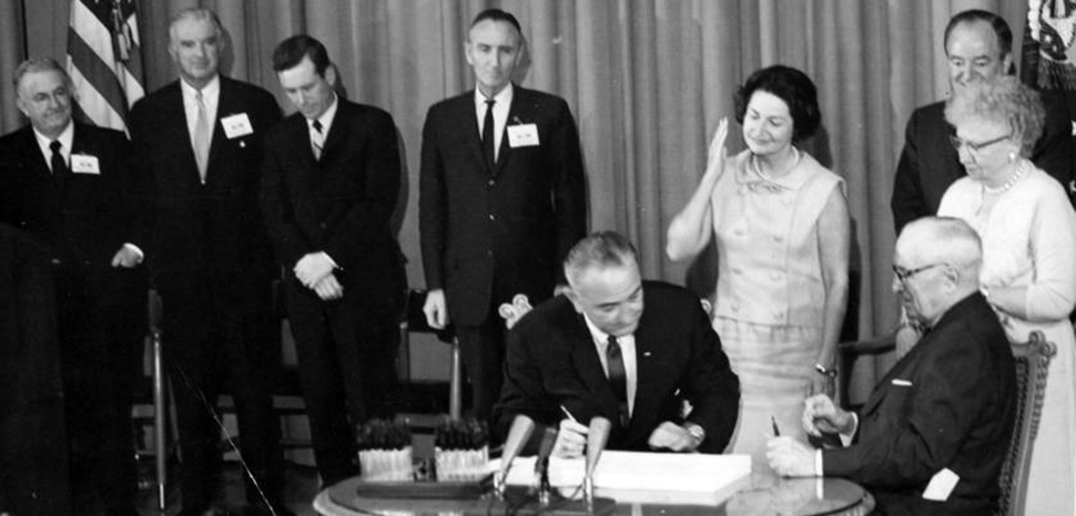 President Johnson signs the Great Society bill, US government, public domain https://commons.wikimedia.org/wiki/File:President_Lyndon_B._Johnson_signs_Medicare_Bill_at_the_Harry_S._Truman_Library,_1965.jpg