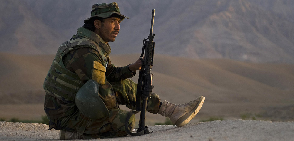 An Afghan commando, with the Afghan National Army’s 3rd Commando Kandak, provides security overwatch via rooftop for fellow Commandos and U.S. Navy SEALs , with Special Operations Task Force – South, during a village clearing operation in Khakrez district, May 6, Kandahar province, Afghanistan. Missions such as these are conducted on a regular basis to hinder Taliban influence throughout the province and increase security for the general populace.
