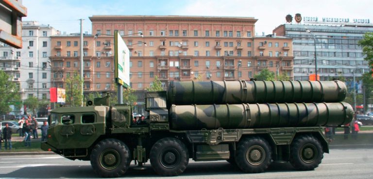 An S-300 anti-aircraft system missile launcher in a Russian military parade. , modified, cc SLonoed, https://commons.wikimedia.org/wiki/File:Side_view_of_a_S-300_launcher.JPG