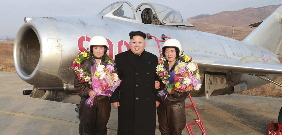 North Korean leader Kim Jong Un poses for pictures with female pilots as he provides field guidance to the flight drill of female pilots of pursuit planes of the KPA Air and Anti-Air Force in this undated photo released by North Korea’s Korean Central News Agency (KCNA) in Pyongyang November 28, 2014. cc Flickr Robert Sullivan, modified, public domain, https://creativecommons.org/publicdomain/mark/1.0/