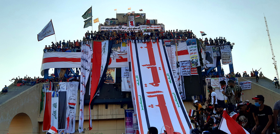 cc Hassan Majed, modified, CC 4.0, https://commons.wikimedia.org/w/index.php?title=Special:Search&title=Special:Search&redirs=0&search=baghdad+protests&fulltext=Search&fulltext=Advanced+search&ns0=1&ns6=1&ns14=1&advanced=1#/media/File:The_Turkish_restaurant,_Iraqi_protests_2019.jpg