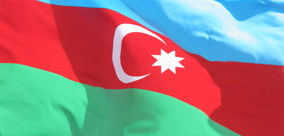 cc Flickr ResoluteSupportMedia, modified, The Azerbaijani national flag ripples from the wind during a recognition ceremony held by Regimental Combat Team 5 at Camp Ripper, Al Asad, Iraq, Dec. 3, 2008. The Azerbaijan forces provided security at the Haditha Dam since August of 2003. (U.S. Marine Corps photo by Staff Sgt. Chad L. Simon/Released), https://creativecommons.org/licenses/by/2.0/