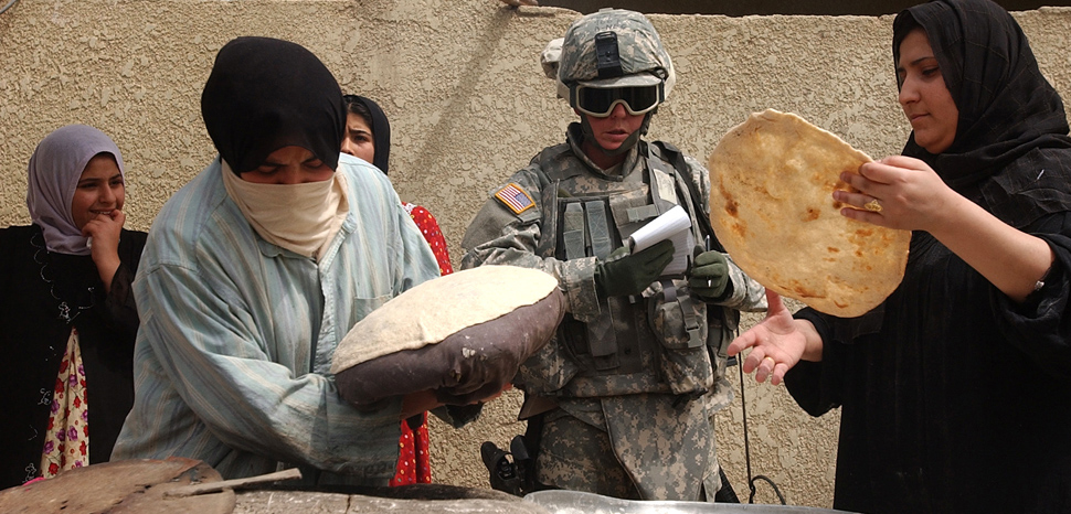 cc The U.S. Army , Flickr, modified, https://creativecommons.org/licenses/by/2.0/, U.S. Army Spc. Christine Foster, with 478th Civil Affairs Company, is taught how to make flat bread by local Iraqi women during a routine meet and greet in the Al Rasheed area of Mahmudiyah, Iraq, May 5, 2007. (U.S. Army photo by Sgt. Jacob H. Smith) (Released)