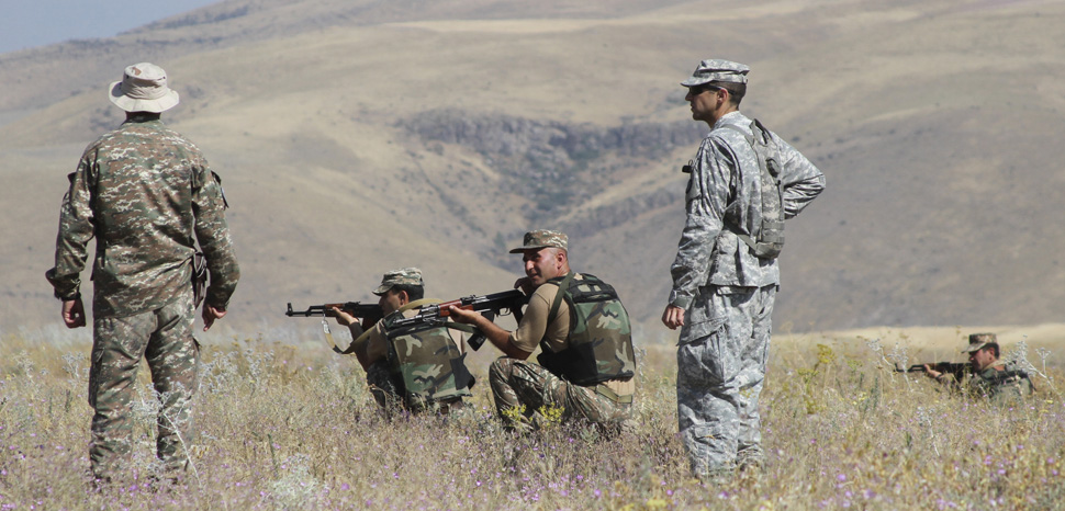 A small group of Kansas Army National Guardsmen share ideas and advise soldiers with the Armenian Peacekeeping Brigade at a training site near Yerevan, Armenia, July 29, 2015. Army National Guard photo by Sgt. Zach Sheely, cc public domain, modiifed, https://www.defense.gov/observe/photo-gallery/igphoto/2001836902/