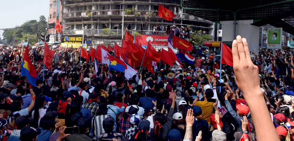 cc VOA Burmese, modified, https://commons.wikimedia.org/w/index.php?title=Special:Search&redirs=0&search=yangon%20protest&fulltext=Search&ns0=1&ns6=1&ns14=1&title=Special:Search&advanced=1&fulltext=Advanced%20search#/media/File:Protesters_participate_in_an_anti-military_rally.jpg