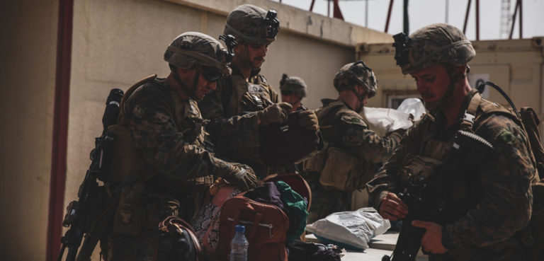 210818-M-TU241-1001 HAMID KARZAI INTERNATIONAL AIRPORT, Afghanistan (August 18, 2021) Marines with the 24th Marine Expeditionary Unit (MEU) search luggage during an evacuation at Hamid Karzai International Airport, Kabul, Afghanistan, Aug. 18. U.S. Marines are assisting the Department of State with an orderly drawdown of designated personnel in Afghanistan., U.S. Marine Corps photo by Sgt. Isaiah Campbell/U.S. Central Command Public Affairs , modified, https://commons.wikimedia.org/w/index.php?title=Special:Search&redirs=0&search=kabul%20airport&fulltext=Search&ns0=1&ns6=1&ns14=1&title=Special:Search&advanced=1&fulltext=Advanced%20search#/media/File:Marines_with_the_24th_Marine_Expeditionary_Unit_(MEU)_search_luggage_during_an_evacuation_at_Hamid_Karzai_International_Airport,_Kabul,_Afghanistan,_Image_6_of_8.jpg