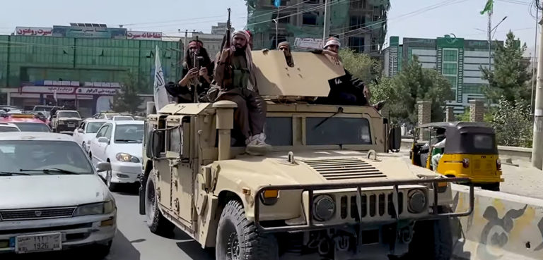 Taliban fighters in a US-supplied Humvee; modified, cc VOA, https://en.wikipedia.org/wiki/Fall_of_Kabul_(2021)#/media/File:Taliban_Humvee_in_Kabul,_August_2021_(cropped).png