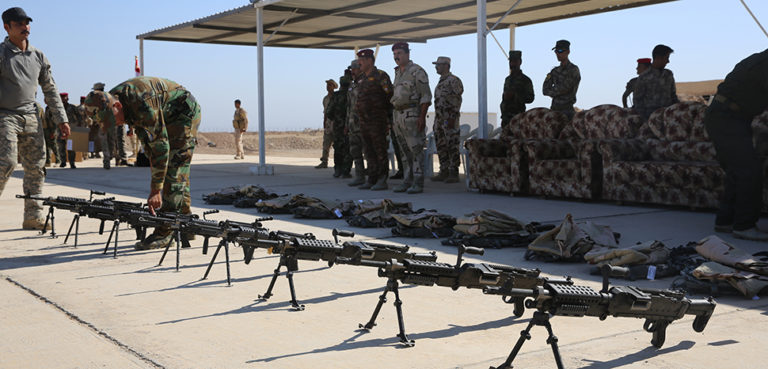 New M240B machine guns, procured and issued through the Iraq Train and Equip Fund, await Popular Mobilization Program soldiers after a graduation ceremony at Al Taqaddum Air Base, Iraq, Sept. 3, 2015. The Popular Mobilization Program is an Iraqi-led, Operation Inherent Resolve program that trains volunteer tribal forces in leadership, small unit tactics and urban warfare to ultimately serve with Iraqi Security Forces in their battle to defeat the Islamic State of Iraq and the Levant and ensure the safety and security of its citizens. (U.S. Marine Corps photo by Cpl. John Baker / released) Unit: 5th Marine Expeditionary Brigade, https://commons.wikimedia.org/w/index.php?title=Special:Search&redirs=0&search=IRAQ%20popular%20mobilization%20unit&fulltext=Search&ns0=1&ns6=1&ns14=1&title=Special:Search&advanced=1&fulltext=Advanced%20search#/media/File:Popular_Mobilization_Program_Graduates_and_Equips_Tribal_Forces_150902-M-VZ998-882.jpg