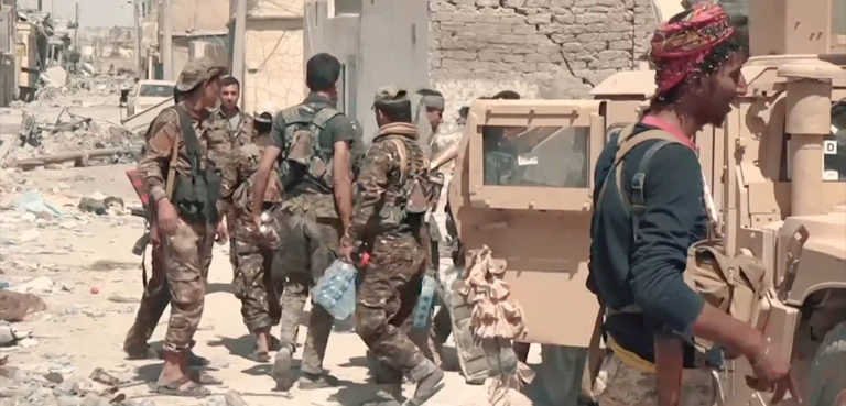 SDF fighters during the Battle of Raqqa, cc Mahmoud Bali (VOA), modified, https://en.wikipedia.org/wiki/Battle_of_Raqqa_%282017%29#/media/File:SDF_fighters_in_central_Raqqa.png