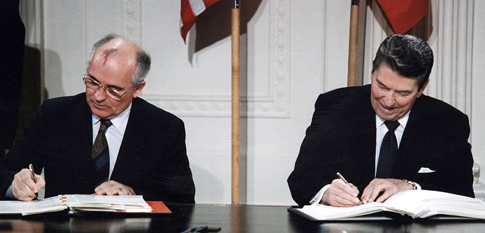 cc White House Photographic Office, modified, https://commons.wikimedia.org/wiki/File:Reagan_and_Gorbachev_signing.jpg, President Ronald Reagan and Mikhail Gorbachev.