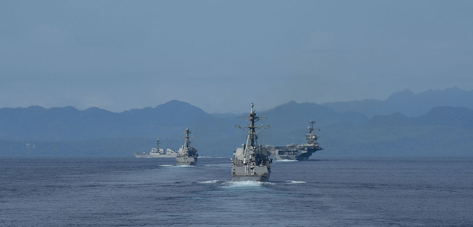 140927-N-GW918-230 PHILIPPINE SEA (Sep. 27, 2014) The Carl Vinson Carrier Strike Group transiting the Surigao Strait in the Philippines as seen from the Ticonderoga-class guided-missile cruiser USS Bunker Hill (CG 52). Bunker Hill is deployed as part of the Carl Vinson Carrier Strike Group supporting maritime security operations, strike operations in Iraq and Syria as directed, and theater security cooperation efforts in the U.S. 5th Fleet area of responsibility. (U.S. Navy photo by Mass Communication Specialist 1st Class LaTunya Howard/Released)