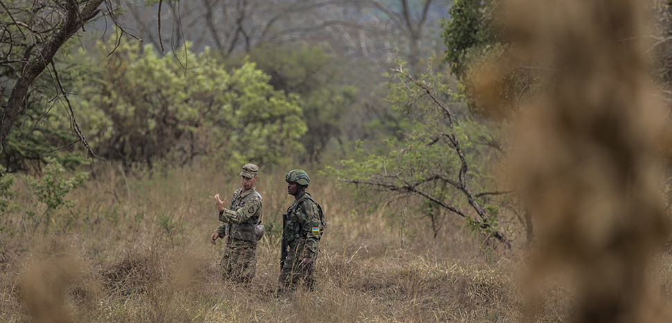 cc US Africa Command, modified, U.S. Army Staff Sgt. James Hartenstein, combat engineer 402nd Engineer Company(Sapper), gives feedback to a member of the Rwanda Defence force during the field training exercise of Exercise Shared Accord 2019, in Gabiro, Rwanda, Aug. 25, 2019. SA 19, which runs Aug. 14-28, is focused on bringing together U.S. and Rwandan forces, African partner militaries, allies and international organizations to increase readiness, interoperability, and partnership building between participating nations for peacekeeping operations in the Central African Republic. (U.S. Army Reserve photo by Sgt. Heather Doppke/79th Theater Sustainment Command), https://flickr.com/photos/africom/48941443818/in/photolist-2h1pudS-2h7dsZY-2h1pDeh-2h7fXrC-2h1qixs-2h7dwYQ-2h7frwX-2h7dvec-2h1px1L-2hyMxxP-2hyQnFG-2hyQwYQ-2h1iZuF-2hyMBuG-2hyQoZy-2hyRqZQ-2hyRona-2hyMESZ-2h1qAKy-2hyRBzY-2hyMyWv-2hyMxUR-2hyRvem-2hyRuTm-2hyMCgr-2hyQmQy-2hyQpfy-2hyMDKt-2hyRsTz-2hyQrRL-2hyMyNz-2hyQtLn-2hyMEhk-2hyMG9S-2h1qLDW-2h1hHb9-2h7fb61-2hyMApW-2hyQBZr-2hyRqmA-2hyRniM-2hyQoo8-2hyMGy9-2hyQvtL-2hyMEs5-2hyMHc8-2hyRqRi-2hyRpkT-2hyQn1o-2hyME3s