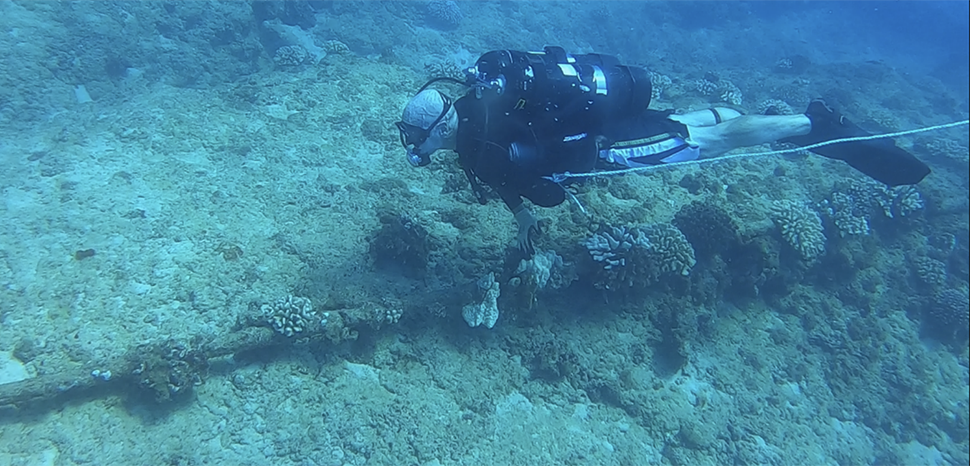                 Members of the Naval Aviation Training Systems and Ranges program office (PMA-205), divers from the Army’s 7th Engineer Dive Detachment, and members of Underwater Tracking Systems at the Pacific Missile Range Facility (PMRF) recently completed a month-long inspection and sustainment operation on critical pieces of undersea infrastructure in Kauai, Hawaii. Lt. Cmdr. Paulstephen Chierico, PMA-205 ocean facilities team lead, visually inspects undersea cables at PMRF on a recent dive. (U.S. Navy Photo)
              