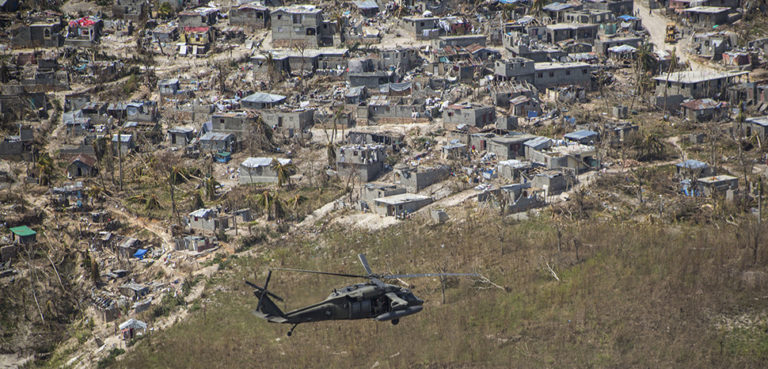 A U.S. Army UH-60 Black Hawk helicopter with Joint Task Force-Bravo’s 1st Battalion, 228th Aviation Regiment, deployed in support of Joint Task Force Matthew, flies toward a supply distribution point in Jeremie, Haiti, Oct. 10, 2016. JTF Matthew, a U.S. Southern Command-directed team, is comprised of Marines with Special Purpose Marine Air-Ground Task Force - Southern Command and soldiers from JTF-Bravo, and is deployed to Port-au-Prince at the request of the Government of Haiti on a mission to provide humanitarian and disaster relief assistance in the aftermath of Hurricane Matthew. (U.S. Marine Corps photo by Cpl. Kimberly Aguirre)