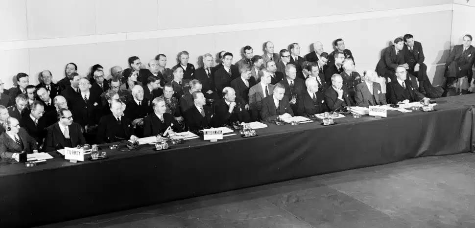 NATO Council Meeting (De Gasperi's Address, Schuman's Address, and Felix Gaillard, Rene Pleven, Herve Alphand, Amb. Draper, 1949 / Public Domain, modified / https://commons.wikimedia.org/w/index.php?search=Rene%20Pleven&ns0=1&ns6=1&ns12=1&ns14=1&ns100=1&ns106=1#/media/File:NATO_Council_Meeting_(De_Gasperi's_Address,_Schuman's_Address,_and_Felix_Gaillard,_Rene_Pleven,_Herve_Alphand,_Amb._Draper,_etc.)_-_DPLA_-_810d9f4b13cd1cabc6fbc149ddac934d.jpg