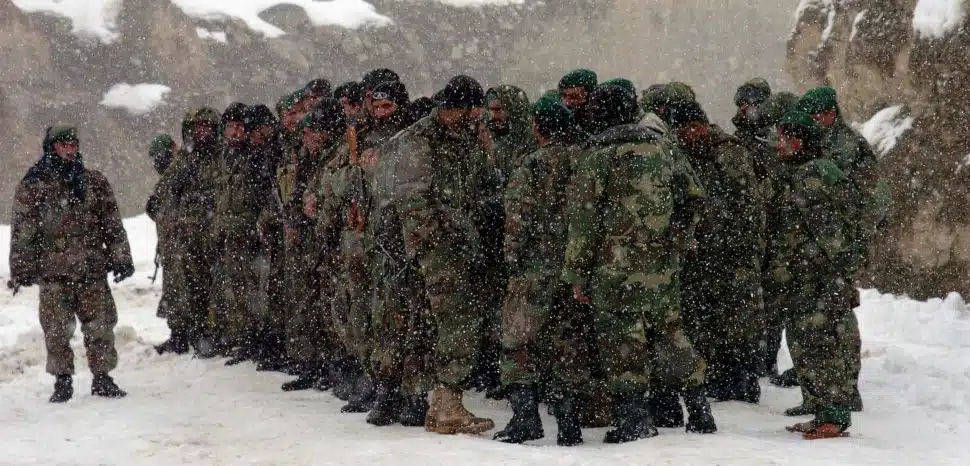 US DOD, modified, Soldiers of the Afghan National Army's 2nd Kandak (Battalion), 3rd Brigade, stand in formation. After ascending Chaperi Mountain, they discovered no survivors of the Kam Air flight that crashed Feb. 4. The team shifted its operation to a victim recovery operation. The ANA will support the International Security Assistance Force in the recovery efforts when weather will permit helicopter flight to the area. Photo by Sgt. 1st Class Mack Davis, USA