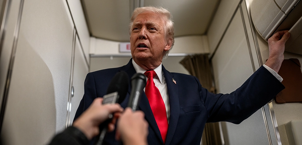 President Donald Trump answers questions from members of the media aboard Air Force One en route to Mount Pocono, Pennsylvania, for a rally on the economy, Tuesday, December 9, 2025. (Official White House Photo by Molly Riley), cc White House, modified, https://commons.wikimedia.org/wiki/File:P20251209MR-0041.jpg