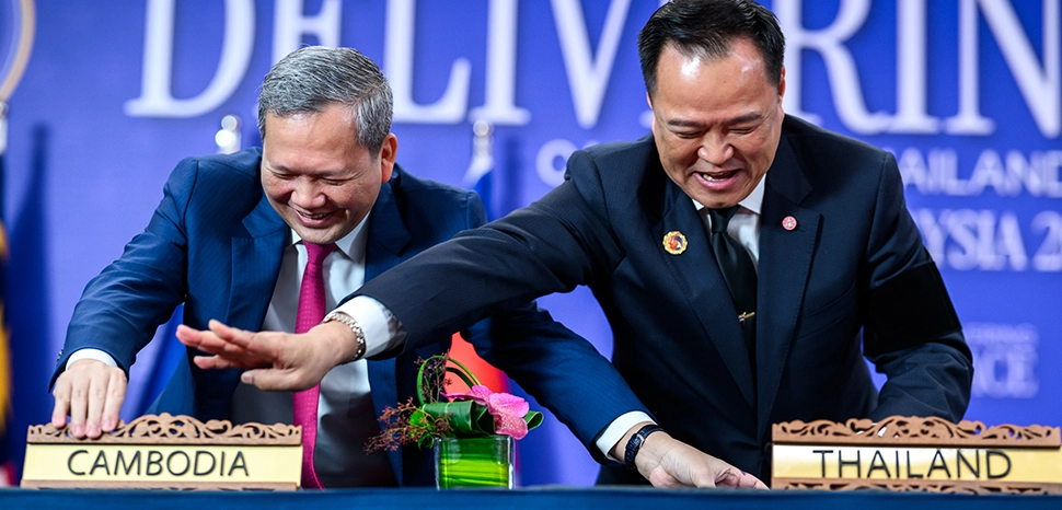                 cc Cambodian Prime Minister Hun Manet and Thailand’s Prime Minister Anutin Charnvirakul laugh while switching name plates after signing the Kuala Lumpur Accord alongside President Donald Trump, Sunday, October 25, 2025, at the ASEAN Summit in Kuala Lumpur, Malaysia. (Official White House Photo by Daniel Torok), modified, https://commons.wikimedia.org/wiki/File:Cambodian_Prime_Minister_Hun_Manet_and_Thailand%E2%80%99s_Prime_Minister_Anutin_Charnvirakul_laugh_while_switching_name_plates_after_signing_the_Kuala_Lumpur_Accord_(54883875700).jpg
              