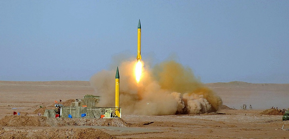 The following sources identify the missiles in this photo as Shahab-1 missiles: [1] [2]. The Shahab-1 is a short-range ballistic missile (MRBM) developed by Iran. Shahab-1 in Great Prophet military exercise; cc Hossein Velayati, modified, https://commons.wikimedia.org/wiki/File:Shahab-1_Missile_by_YPA.IR_02.jpg
