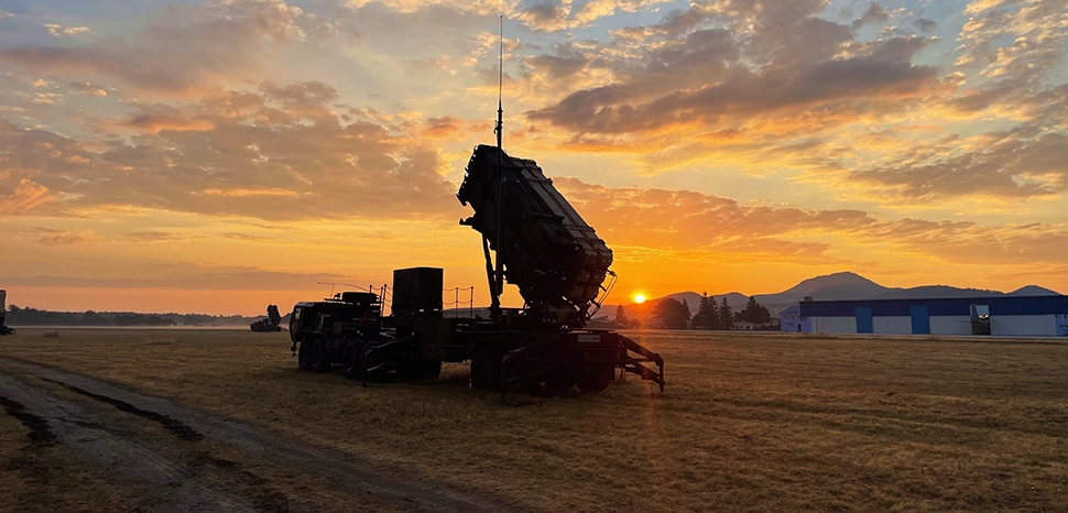 The sun rises over a 10th AAMDC Patriot missile launcher in Slovakia on July 27. Bravo Battery, 5-7 Air Defense Artillery is preparing for crew qualification tables and NATO readiness evaluations in the coming weeks while deployed to Slovakia providing increased air defense capacity and capability along NATO's Eastern flank. (U.S. Army photo by 2nd Lt. Emily Park)