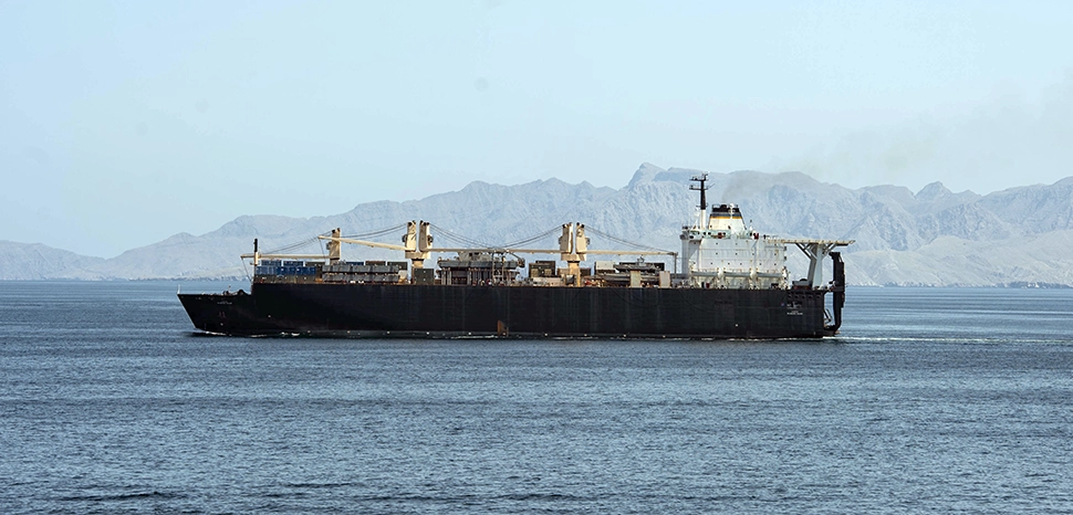 The U.S. Military sealift command dry cargo ship USNS PFC Dewayne T. Williams (T-AK-3009) transits the Strait of Hormuz on 17 April 2020.; cc US Navy, modified, https://commons.wikimedia.org/wiki/File:USNS_PFC_Dewayne_T._Williams_%28T-AK-3009%29_underway_in_the_Strait_of_Hormuz_on_17_April_2020_%28200417-N-PI330-0057%29.JPG